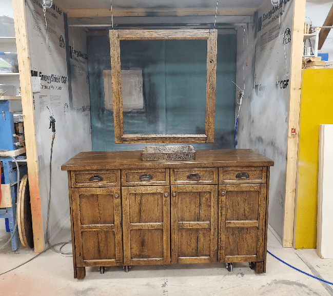 There are two large wooden cabinets, one being built and the other already completed.